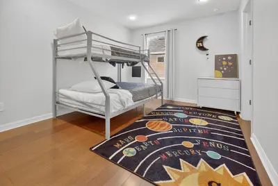 a bedroom with a bunk bed and a rug at 290 LF - BellaVida Cozy 6BR Pool Home in Kissimmee