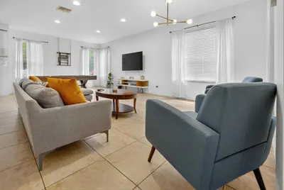 a living room with two chairs and a couch at 290 LF - BellaVida Cozy 6BR Pool Home in Kissimmee