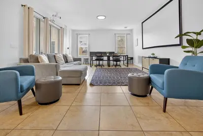 a living room with a couch and chairs and a table at 290 LF - BellaVida Cozy 6BR Pool Home in Kissimmee