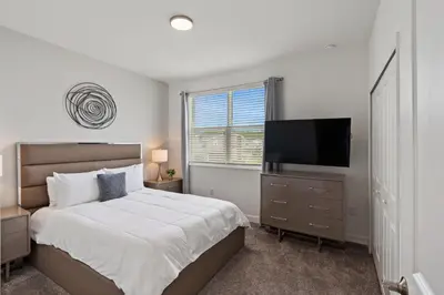 a bedroom with a bed and a flat screen tv at 4238 Paragraph in Kissimmee