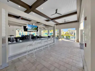 a lobby with a bar with stools at 4238 Paragraph in Kissimmee