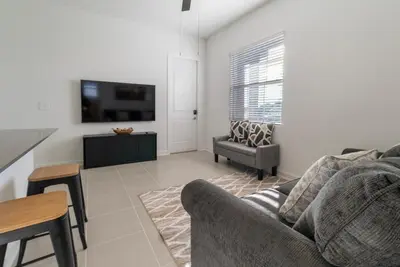 a living room with a couch and a tv at Remote workers apartment or Long Stay Home