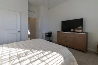 a bedroom with a bed and a flat screen tv at Remote workers apartment or Long Stay Home
