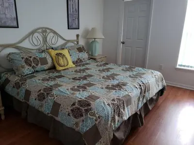 a bedroom with a bed with a quilt on it at Lake Therapy by Paradise Resort Vacations in Orlando