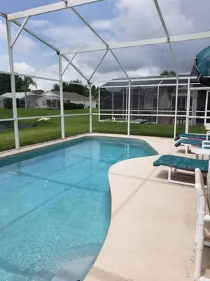 a swimming pool with a tent and two chairs at Lake Therapy by Paradise Resort Vacations in Orlando