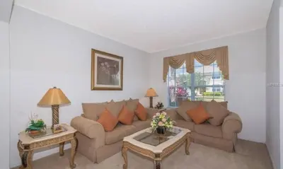 a living room with a couch and two tables at Sunset Bliss Escape by Paradise Resort Vacations in Kissimmee