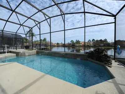 a large swimming pool with a large glass building at Sunshine Oasis Villa by Paradise Resort Vacations in Kissimmee
