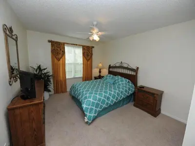 a bedroom with a bed and a television in it at Sunshine Oasis Villa by Paradise Resort Vacations in Kissimmee