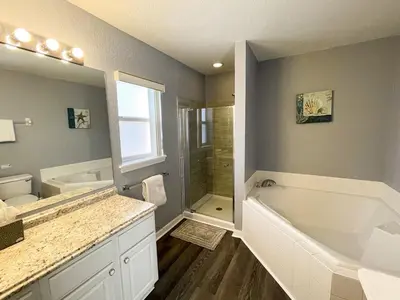 a bathroom with a tub and a sink and a shower at Woodcrest Luxury by Paradise Resort Vacations in Orlando