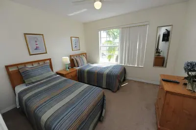 a bedroom with two beds and a window at Ruby-rose Retreat in Kissimmee