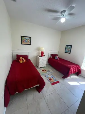 a bedroom with two beds and a ceiling fan at Ruby-rose Retreat in Kissimmee
