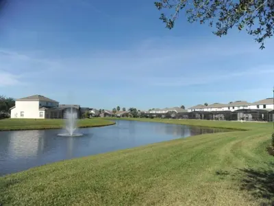 a pond with a fountain in the middle of a park at Ruby-rose Retreat in Kissimmee