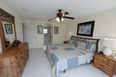 a bedroom with a bed and a ceiling fan at Ruby-rose Retreat in Kissimmee