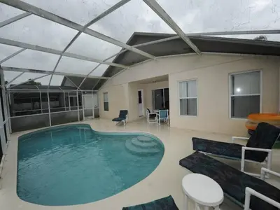 a large pool in a room with a couch and a table at Palmview Villa by Paradise Resort Vacations in Orlando