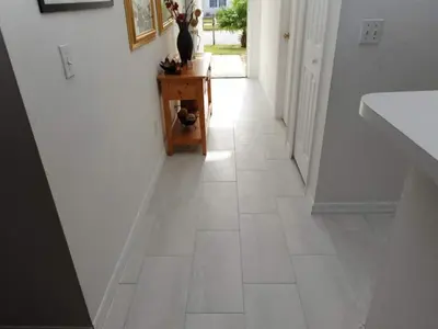 a hallway with a white tile floor in a house at Palmview Villa by Paradise Resort Vacations in Orlando