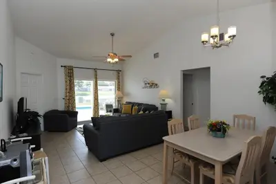 a living room with a couch and a table at Holiday Hideout in Orlando