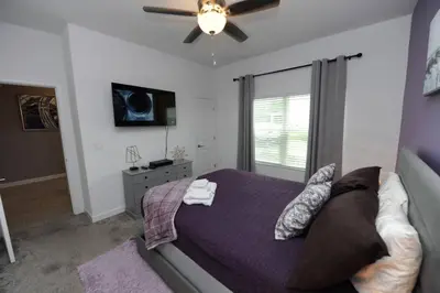 a bedroom with a bed and a ceiling fan at The Cove At East Storey Lake in Kissimmee