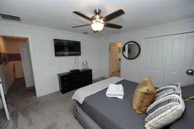 a bedroom with a bed and a ceiling fan at The Cove At East Storey Lake in Kissimmee