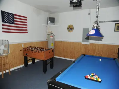a room with a pool table and an american flag at Tranquil Waters Haven in Kissimmee