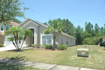 a house with a generator in a yard at Serenity Retreat Near Disney in Kissimmee