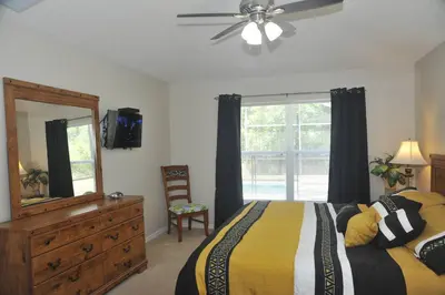 a bedroom with a bed and a dresser and a mirror at Serenity Retreat Near Disney in Kissimmee
