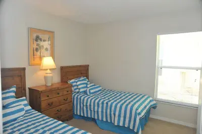 a bedroom with two beds and a lamp and a window at Serenity Retreat Near Disney in Kissimmee