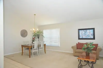 a living room with a table and a couch at Serenity Retreat Near Disney in Kissimmee