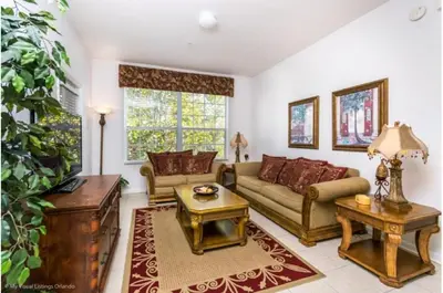 a living room with a couch and a table at Three-Bedroom Apartment Kissimmee in Orlando