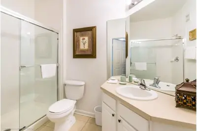 a bathroom with a toilet and a sink and a shower at Three-Bedroom Townhome Kissimmee in Orlando