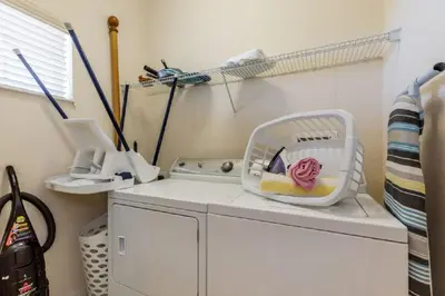 a washing machine with a basket on top of it at Three-Bedroom Townhome Kissimmee in Orlando