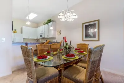 a kitchen and dining room with a table and chairs at Three-Bedroom Townhome Kissimmee in Orlando