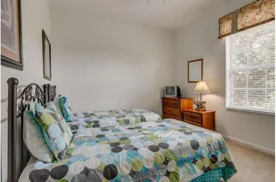 a bedroom with a bed and a window at Three-Bedroom Townhome Kissimmee in Orlando