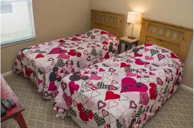 a bedroom with a bed with a bedspread with hearts at Three-Bedroom Pool Home Kissimmee in Orlando