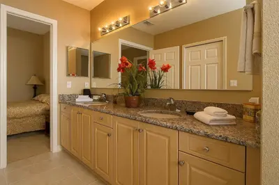 a bathroom with a sink and a large mirror at Luxury 3-bed Condo Near Disney Worldquest Resort in Orlando