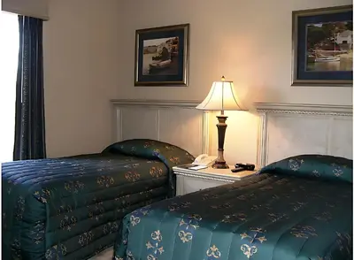 a hotel room with two beds and a lamp at Luxury 3-bed Condo Near Disney Worldquest Resort in Orlando