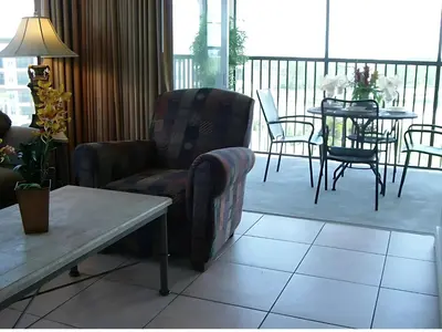 a living room with chairs and a table on a balcony at Luxury 3-bed Condo Near Disney Worldquest Resort in Orlando