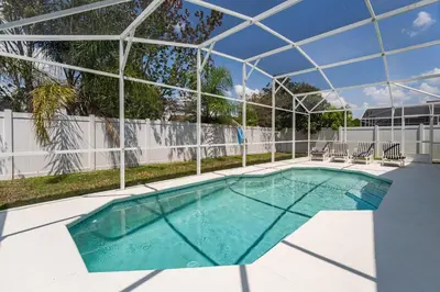 a swimming pool with a glass cover over it at Near Disney Private Pool 4 Bedrooms in Kissimmee