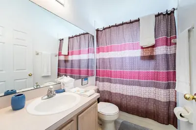 a bathroom with a sink and a toilet at Near Disney Private Pool 4 Bedrooms in Kissimmee