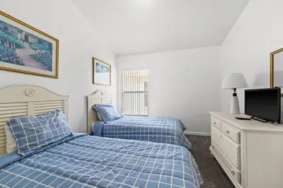 a bedroom with two beds and a television in it at Near Disney Private Pool 4 Bedrooms in Kissimmee