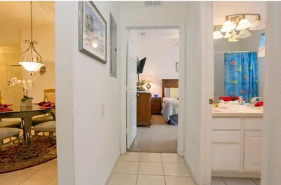 a hallway of a home with a kitchen and a dining room at DREAM Vacation BY A3G in Orlando