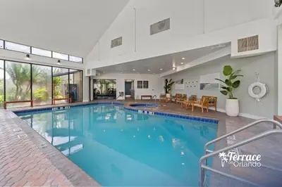 a large swimming pool in a house at Relaxing Central Condo with Balcony 7 Min to Universal in Orlando