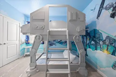 a room with a bunk bed with a ladder at 12BR Disney Home | Sleeps 30+, GameRoom, POOL/SPA! in Kissimmee