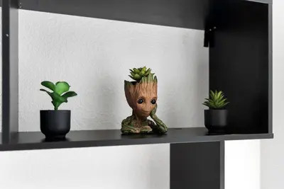 a figurine of a baby groot sitting on a shelf at 4BD Family Pool Home, Near Disney & Workspace in Orlando