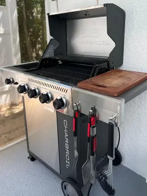 a grill on a stand with a cutting board on it at 4BD Family Pool Home, Near Disney & Workspace in Orlando