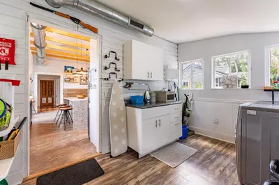 a kitchen with white cabinets and a counter top at Cozy 3BR Retreat - Near Bars Zoo & Lake Trails in Sanford