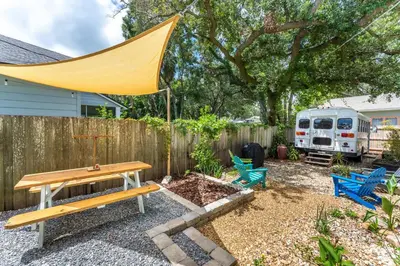 a backyard with a picnic table and chairs and a fence at Cozy 3BR Retreat - Near Bars Zoo & Lake Trails in Sanford
