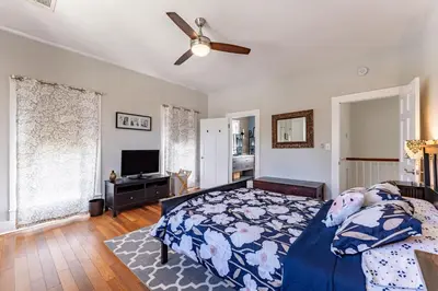 a bedroom with a bed and a ceiling fan at Cozy 3BR Retreat - Near Bars Zoo & Lake Trails in Sanford