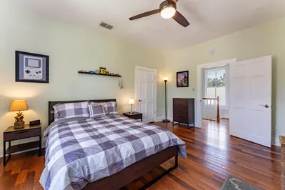 a bedroom with a bed and a ceiling fan at Cozy 3BR Retreat - Near Bars Zoo & Lake Trails in Sanford