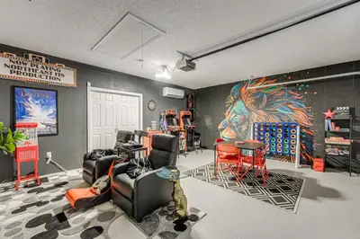 a room with chairs and a painting on the wall at Disney Getaway with Private Hot Tub 14 Mi to Parks in Kissimmee