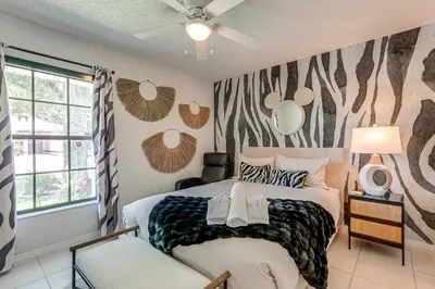 a bedroom with a bed and a window at Disney Getaway with Private Hot Tub 14 Mi to Parks in Kissimmee